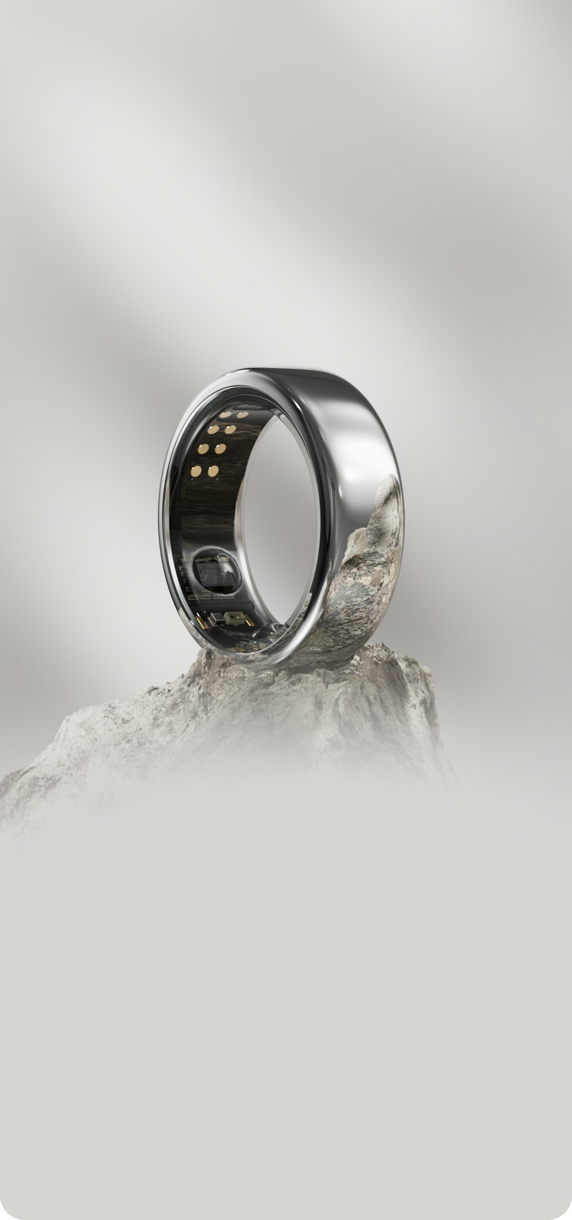Oura Ring Horizon Silver showcased atop a mountain top
