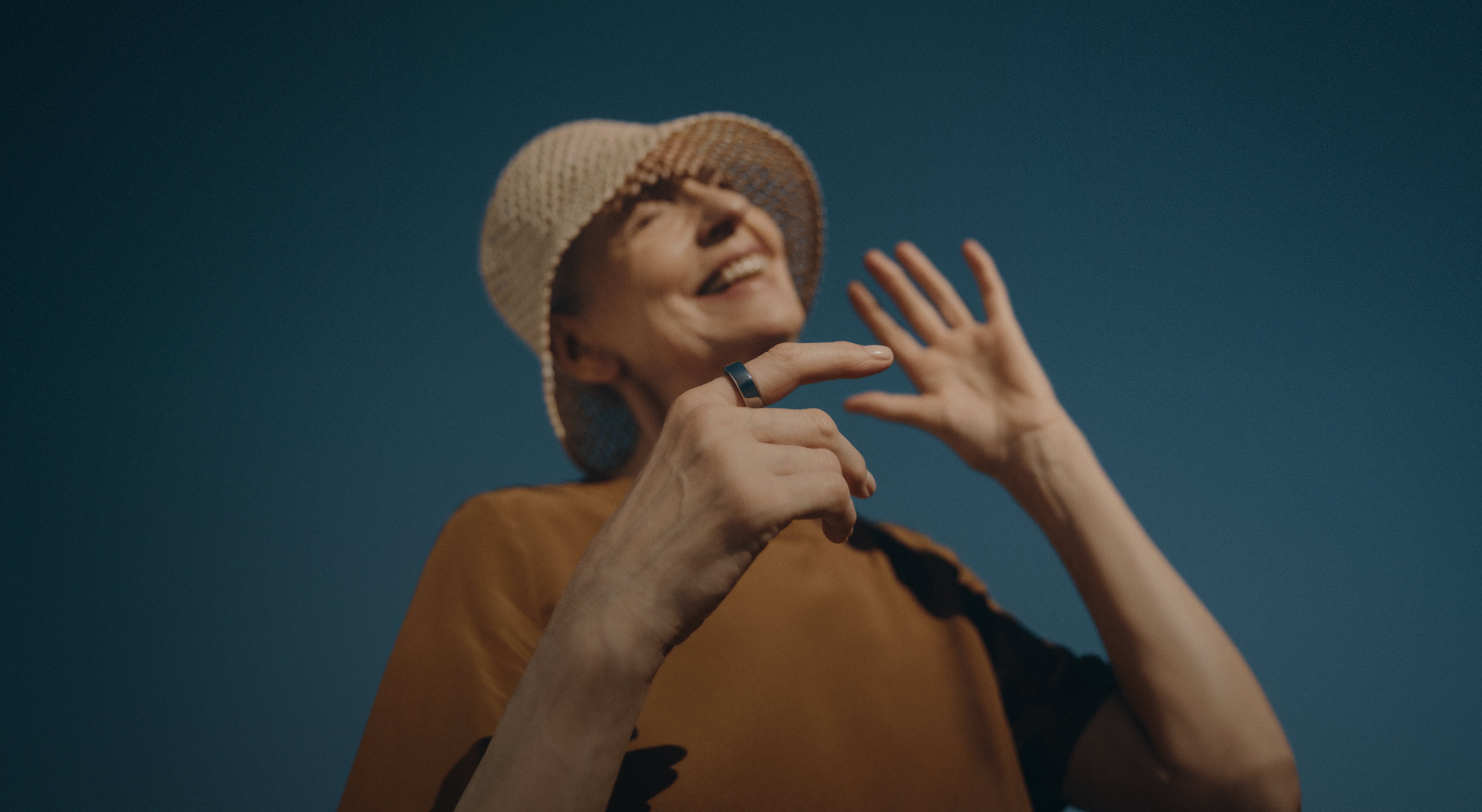 Woman in hat enjoying the sunshine while wearing Oura ring