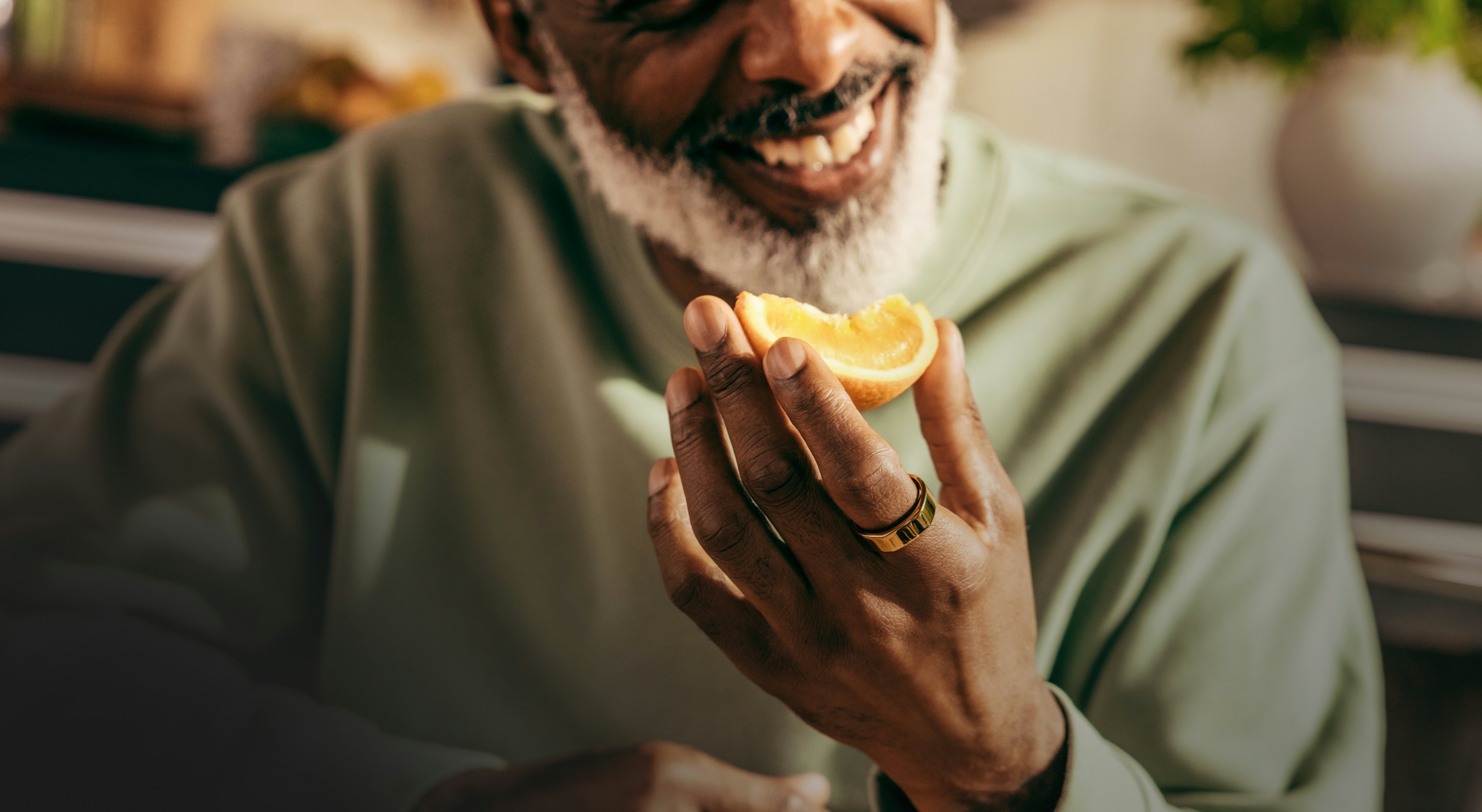 Man eating an orange while wearing his Oura ring
