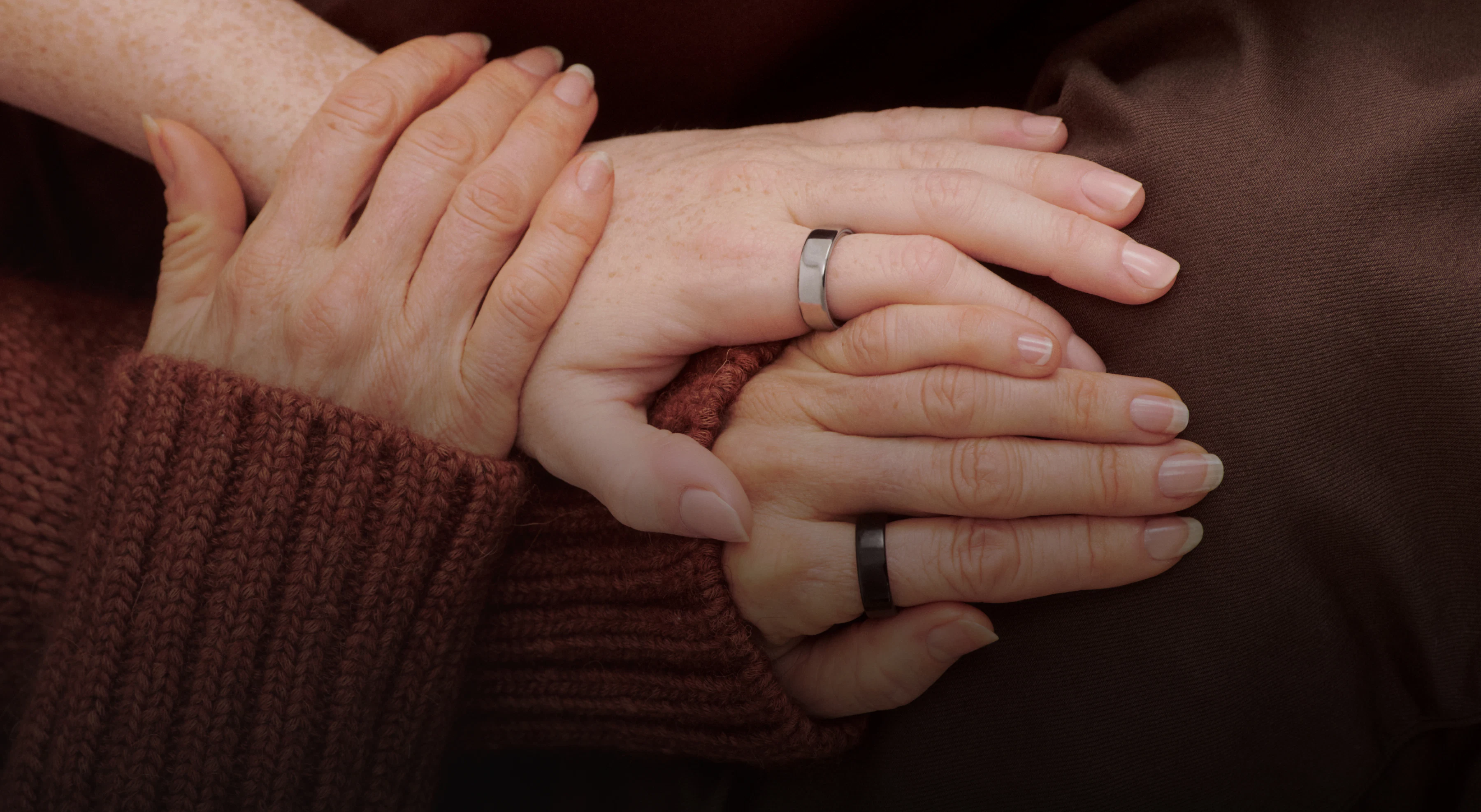 Holding hands each wearing an Oura Ring 5